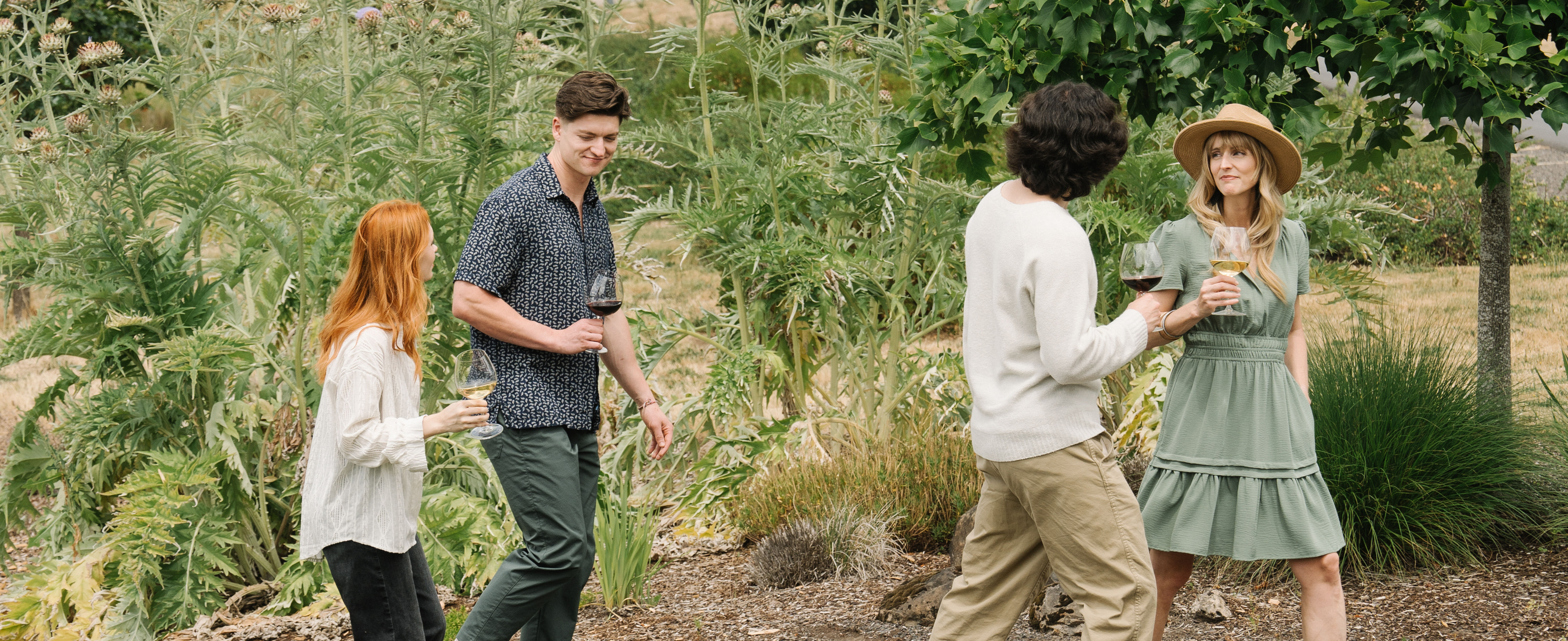 A group of people walking the winery property