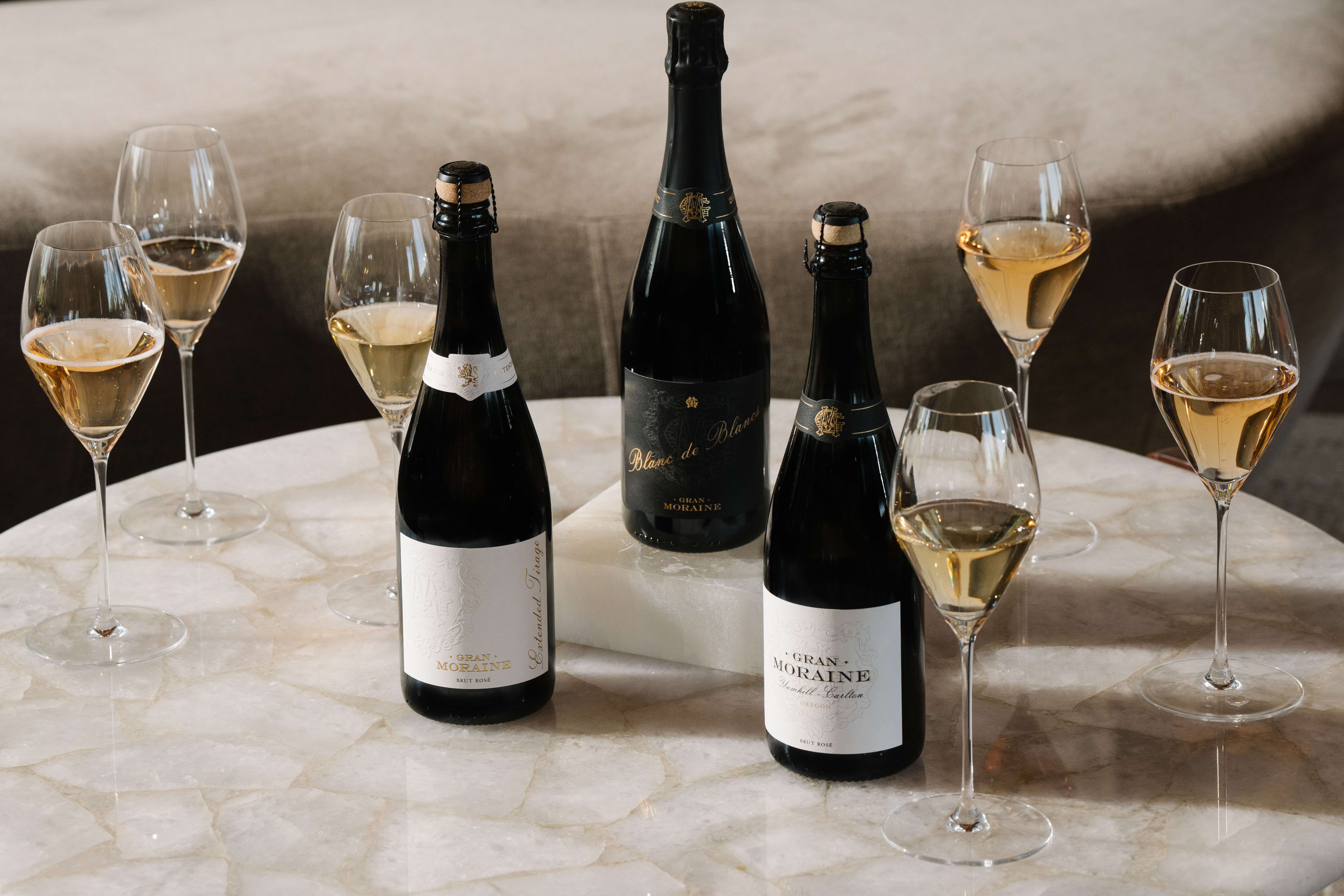 Three sparkling wine bottles
