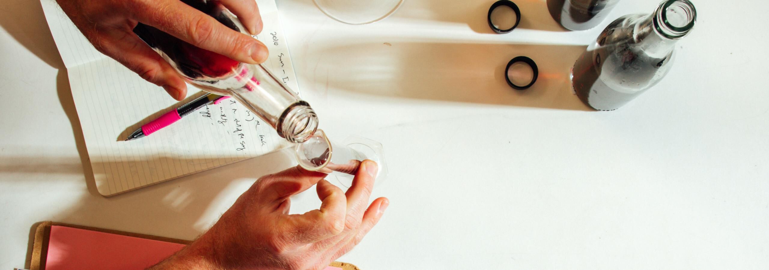 Overhead shot of a person blending wine in a lab