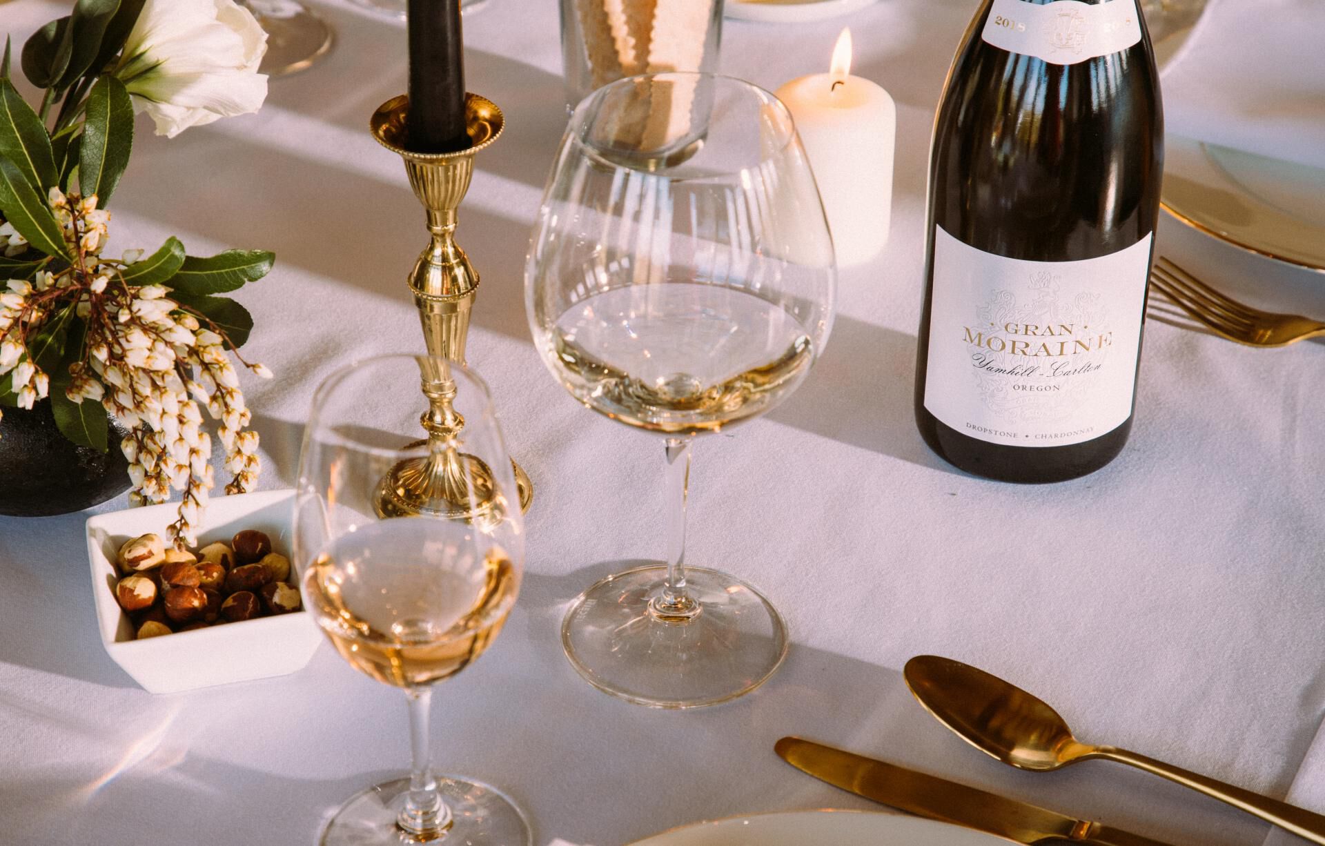 Glasses of white wine on an elegently set table